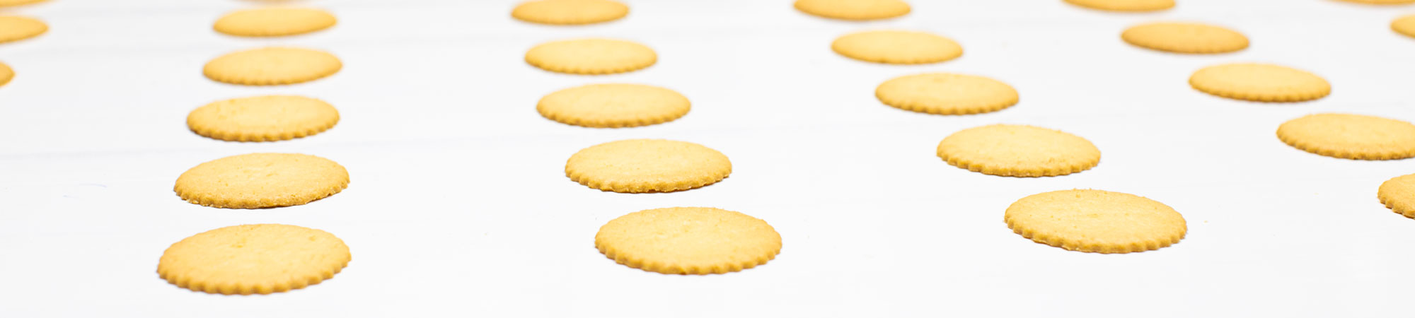 ThinCookiesBanner Three Dewey's employees manufacturing cookies